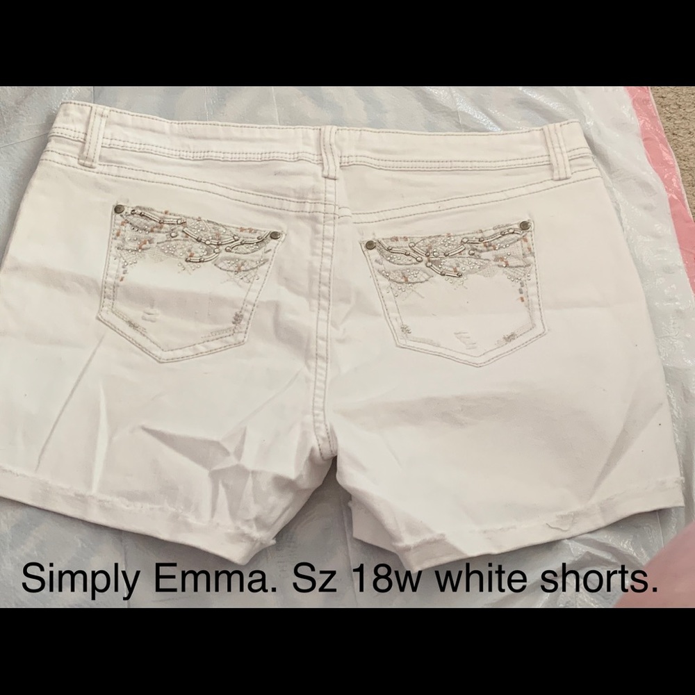 White shorts. Design on pockets